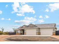 Charming single-story home with a three-car garage and a beautifully tiled roof under a partly cloudy sky at 27420 N 170Th St, Rio Verde, AZ 85263