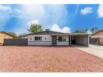 Charming single story home with light gray exterior paint and desert landscaping at 3201 W Caribbean Ln, Phoenix, AZ 85053