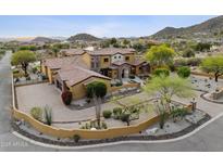 Stunning desert home featuring lush landscaping, a circular driveway, and picturesque mountain views at 3312 N 89Th Pl, Mesa, AZ 85207