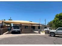 Charming single-story home featuring a large carport and a well-maintained front yard at 4426 N 34Th Dr, Phoenix, AZ 85017