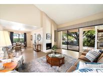 Spacious living room with fireplace, comfortable seating, and views of the back patio at 5465 N 78Th St, Scottsdale, AZ 85250