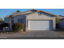 Charming single-story home features a two-car garage, desert landscaping, and a neutral color palette at 6538 W Elwood St, Phoenix, AZ 85043