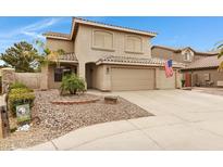 Charming two-story home with a three-car garage and well-maintained landscaping at 9665 E Nido Ave, Mesa, AZ 85209