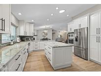 Open concept kitchen with white cabinets, granite countertops, and stainless steel appliances at 12411 N 57Th St, Scottsdale, AZ 85254