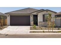 Charming single-story home with a two-car garage and well-maintained desert landscaping at 16015 W Desert Hollow Dr, Surprise, AZ 85387