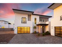 Modern two-story home boasts a contemporary design, complete with a striking garage door and manicured landscaping at 100 W Northern Ave # 6, Phoenix, AZ 85021