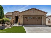 Charming single-story home featuring a low maintenance front yard, stone accents, and a two-car garage at 12353 W Running Deer Trl, Peoria, AZ 85383