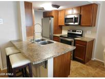 Updated kitchen with stainless steel appliances and granite countertops at 14636 N Yerba Buena Way # B, Fountain Hills, AZ 85268