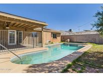 Backyard pool featuring cool blue water, a lounging area, and a covered patio area at 2049 W Joan De Arc Ave, Phoenix, AZ 85029