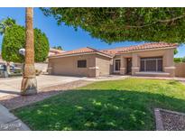 Charming single-Gathering home with manicured lawn, desert landscaping, and a two-car garage at 21313 N 59Th Dr, Glendale, AZ 85308
