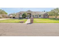 Charming single-story home boasting a well-manicured lawn and inviting curb appeal at 23455 S 199Th Pl, Queen Creek, AZ 85142