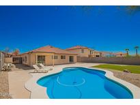 Inviting backyard pool with lounge chairs and desert landscaping, perfect for outdoor relaxation and entertaining at 252 S Canfield --, Mesa, AZ 85208