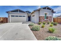Charming single-story home with a two-car garage, stone accents, desert landscaping, and a cozy front porch at 3347 E Malibu Dr, San Tan Valley, AZ 85143