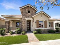Charming single-story home featuring a stone facade, well-manicured landscaping, and a welcoming entryway at 4171 E Ronald St, Gilbert, AZ 85295