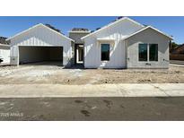 Charming new construction home featuring bright white siding and a spacious two car garage at 6460 E Omega Cir, Mesa, AZ 85215