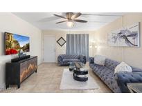 Cozy living room with stylish sofas, modern decor, and a ceiling fan for comfortable living at 7110 E Continental Dr # 1044, Scottsdale, AZ 85257
