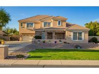 Charming two-story home featuring a stone facade, landscaped yard, and well-manicured lawn at 950 E Desert Inn Dr, Chandler, AZ 85249