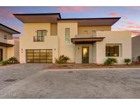 Contemporary two-story home with a two-car garage and meticulously landscaped front yard at 100 W Northern Ave # 4, Phoenix, AZ 85021