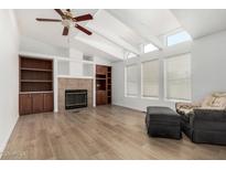 Inviting living room with fireplace, wood floors, and beamed ceilings at 2929 E Sequoia Dr, Phoenix, AZ 85050