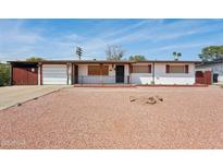 Cozy single-story home featuring a well-kept exterior with a charming front yard at 1214 E Butler Dr, Phoenix, AZ 85020