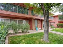 Charming two-story home with brick accents, a well-maintained lawn, and mature trees at 130 E Coronado Rd # 16, Phoenix, AZ 85004