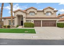 Charming two-story home featuring a well-manicured lawn, tile roof, and inviting curb appeal at 14841 N 62Nd Way, Scottsdale, AZ 85254