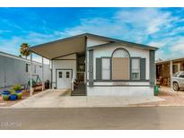 Inviting single-level home features a covered carport and well-manicured landscaping at 17200 W Bell Rd # 1643, Surprise, AZ 85374