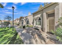 Charming single story home featuring neutral toned stucco, low maintenance landscaping and covered front entryway at 500 N Roosevelt Ave # 61, Chandler, AZ 85226