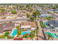 Beautiful aerial shot of a neighborhood, featuring a home with a private pool and well-maintained backyard at 6608 S Willow Dr, Tempe, AZ 85283