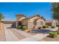 Charming single-story home with a stone-accented facade, desert landscaping, and a two-car garage at 870 E Runaway Bay Pl, Chandler, AZ 85249