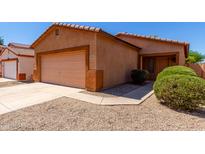 Charming single-story home with a two-car garage, desert landscaping, and a cozy front entrance at 1384 E Press Rd, San Tan Valley, AZ 85140