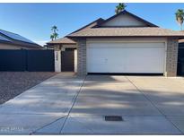 Charming single-story home with a two-car garage and well-maintained front yard at 1833 E Bluefield Ave, Phoenix, AZ 85022