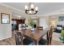 Inviting dining area featuring a chandelier and wood table, set in a neutral color palette at 20801 N 90Th Pl # 242, Scottsdale, AZ 85255