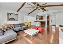 Bright living room showcasing a gray couch, ceiling fan, hardwood floors, and a modern design at 6747 N 12Th St, Phoenix, AZ 85014