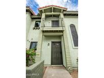 Two-story home with green exterior, black trim, gated entry, and balcony at 2315 W Union Hills Dr # 120, Phoenix, AZ 85027