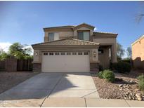 Inviting two-story home featuring desert landscaping, a two-car garage, and a neutral color palette at 23236 W Yavapai St, Buckeye, AZ 85326
