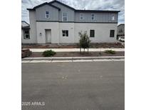 Charming two-story home with a well-maintained lawn and fresh landscaping at 2455 W Rowel Rd, Phoenix, AZ 85085