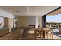 Bright and airy living room featuring modern kitchen island, sleek fireplace, and outdoor seating with mountain views at 4849 N Camelback Ridge Rd # A309, Scottsdale, AZ 85251