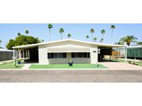 Charming single-story home featuring well-maintained landscaping with palm trees and covered parking at 120 N Val Vista Dr # 230, Mesa, AZ 85213