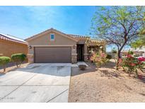 Well-maintained single-story home with a two-car garage and easy to maintain landscaping at 12033 W Davis Ln, Avondale, AZ 85323