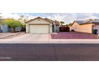 Charming single-story home featuring a two-car garage and mature landscaping at 1758 E Birch St, Casa Grande, AZ 85122