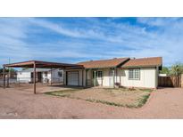 Charming single-story home featuring a carport, one-car garage, and traditional-style windows at 2002 S Apache Dr, Apache Junction, AZ 85120
