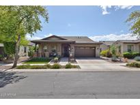 Charming single-story home featuring a well-manicured lawn and inviting front porch at 20631 W Minnezona Ave, Buckeye, AZ 85396