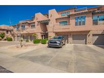 Condominium exterior showcasing well-maintained grounds, garage parking, and attractive architecture at 20660 N 40Th St # 1112, Phoenix, AZ 85050