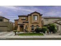 Stunning two-story stucco home with a tile roof, arched windows, and a well-manicured lawn at 2673 E Remington Pl, Chandler, AZ 85286