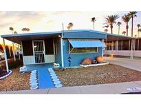 Charming single-story home featuring desert landscaping and blue accents at 303 S Recker Rd # 74, Mesa, AZ 85206