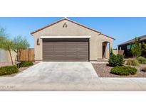 Tan single-story home with a brown garage door, tile roof, and desert landscaping at 3670 E Sandoval Dr, San Tan Valley, AZ 85140