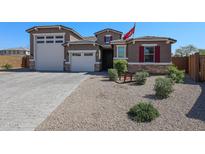 Charming home exterior with a well-manicured front yard and a three car garage at 3907 S 75Th Dr, Phoenix, AZ 85043