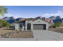 Charming single-story home with a two-car garage and desert landscaping, set against a backdrop of majestic mountains at 5686 E Smeaton Pl, San Tan Valley, AZ 85140