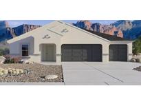 Charming single-story home with a three-car garage and a low-maintenance desert landscape at 5693 E Axle Ln, San Tan Valley, AZ 85140